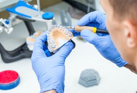 Lab technician carving dentures