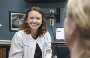 Doctor Whitaker smiling at a dental patient